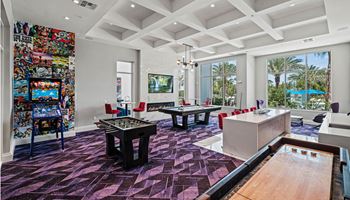A game room with a pool table and ping pong
